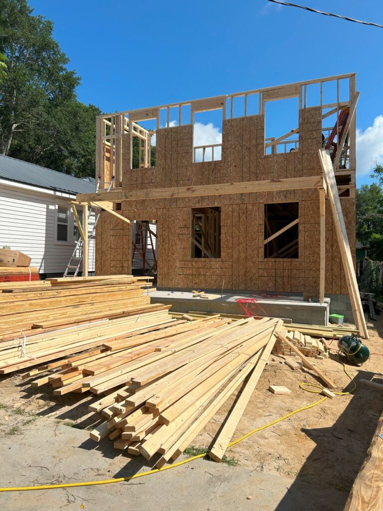 New home construction in progress with wood framing by Legacy Renovations